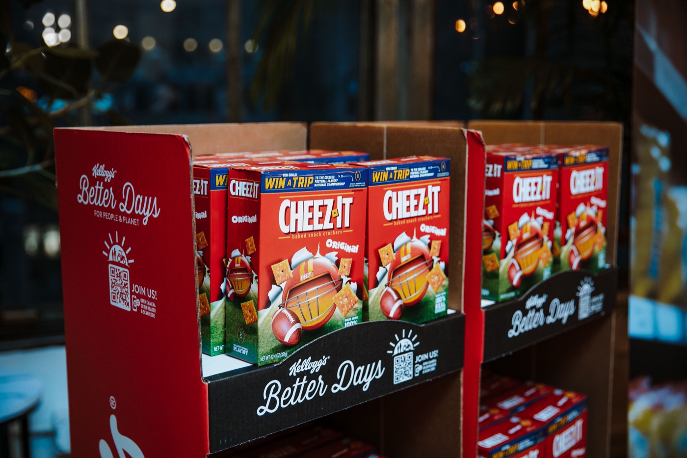 Red cardboard display with boxes of "CHEEZ-IT" crackers and a "Kellogg's Better Days" strip